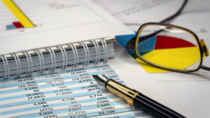 Accounting business. Glasses and pen with accounting report